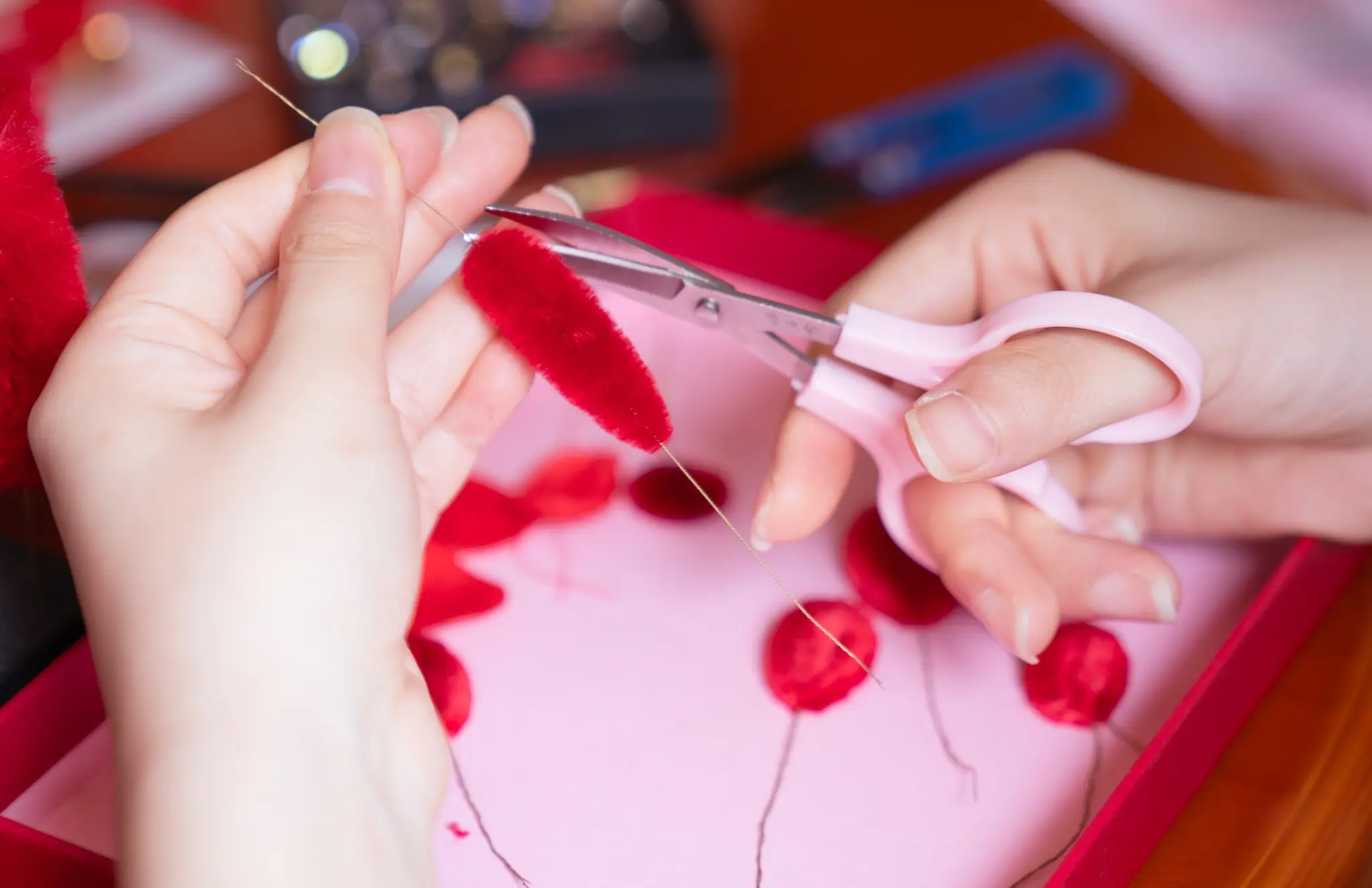 Hands shaping a traditional wrapped silk flower